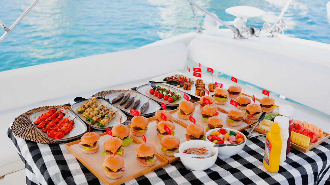 Yacht proposal setup in Dubai — rose petals, candles and champagne