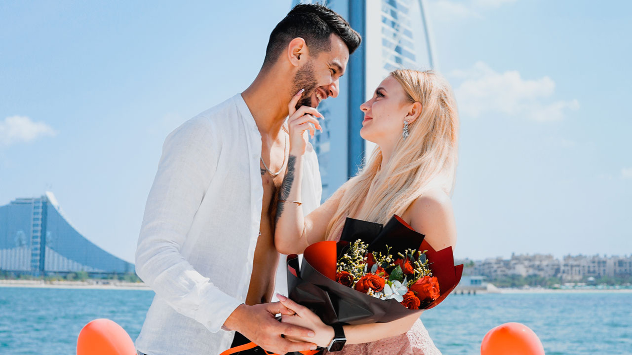 Yacht proposal setup in Dubai — rose petals, candles and champagne