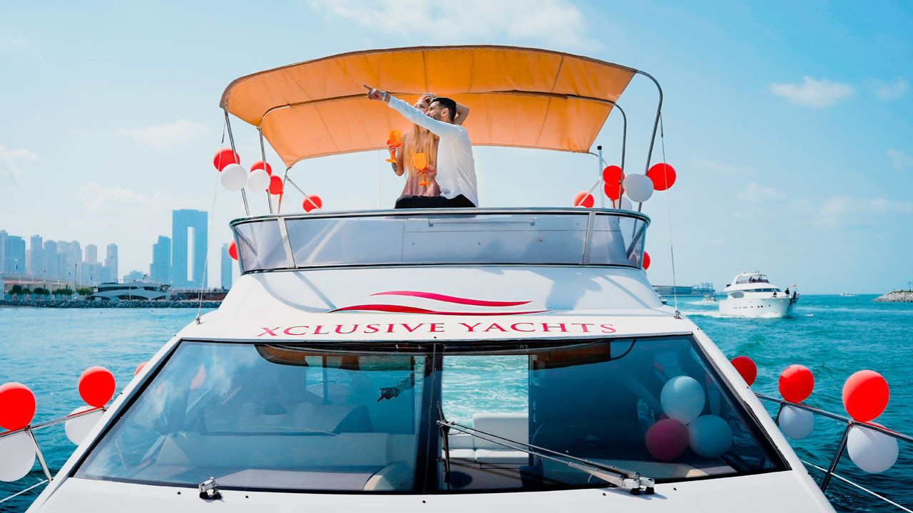 Yacht proposal setup in Dubai — rose petals, candles and champagne